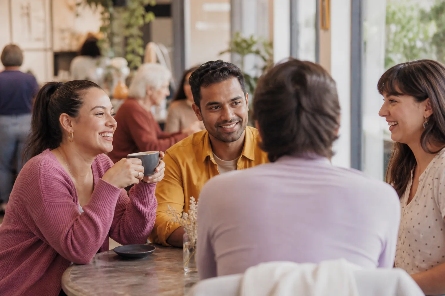 Two London singles talking over coffee at a neighbourhood café