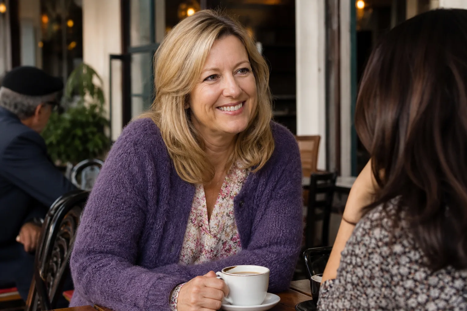 An older woman and a man talking over coffee in London